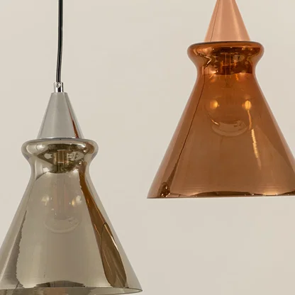 Silver and copper glass pendant lights illuminated to showcase luxury decorative ceiling lighting with modern elegance.