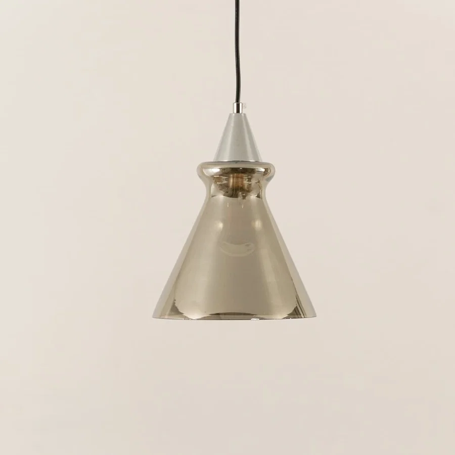 Silver glass pendant light illuminated to display sophisticated modern ceiling lighting with elegant decorative styling.