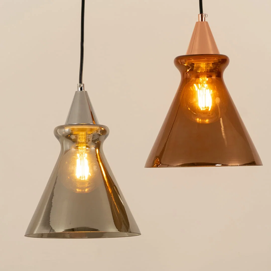 Silver and copper glass pendant lights illuminated to highlight premium craftsmanship and elegant ambient lighting design.