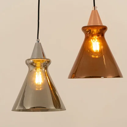 Silver and copper glass pendant lights illuminated to highlight premium craftsmanship and elegant ambient lighting design.