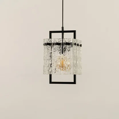 Black metal wall light with crystal glass detailing illuminated to display elegant contemporary lighting appeal.