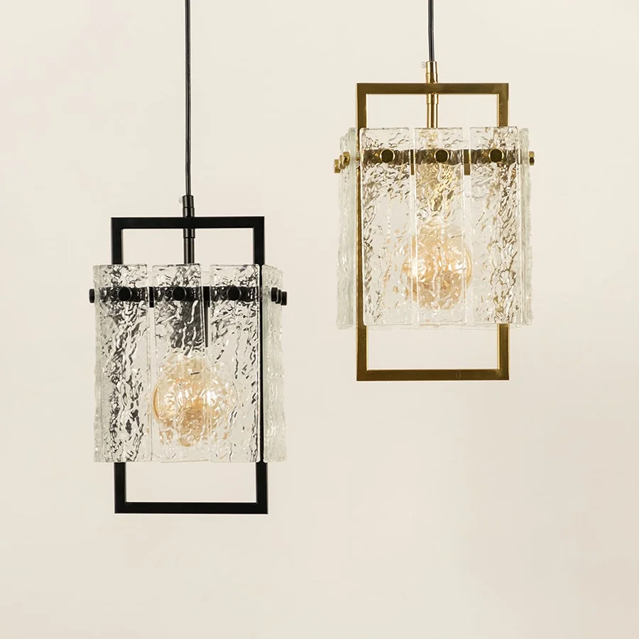 Black and gold metal wall lights illuminated to highlight luxury crystal detailing and refined modern craftsmanship.