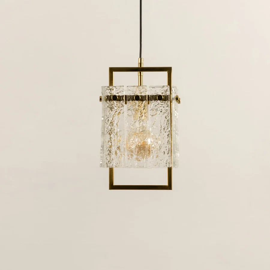 Gold metal wall light with crystal glass accents illuminated to showcase luxury decorative wall lighting elegance.