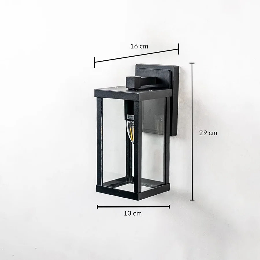 Outdoor wall light with black frame and glass shade shown with 29 cm height 16 cm width and 13 cm depth dimensions.
