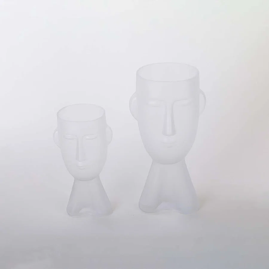 Set of frosted glass vases in abstract face design matte white finish decorative modern accents light on white background for home.