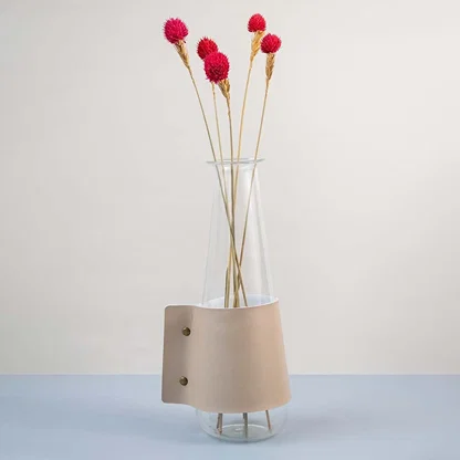 Bright red dried flower stem styled in a warm modern room adding a bold natural accent to contemporary home decor.