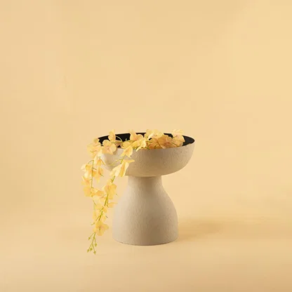 Grey textured pedestal vase bowl with black interior styled in a warm minimal scene adding modern elegance to home decor.