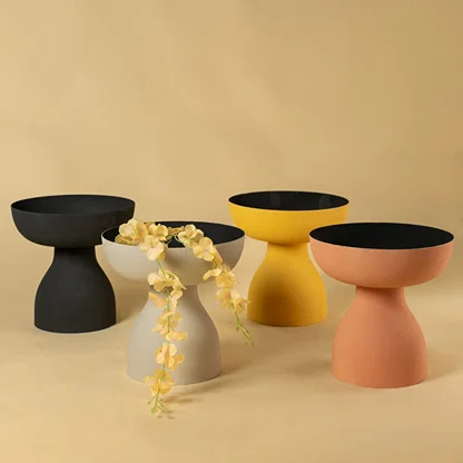 Set of four matte pedestal bowls in neutral tones for luxury home decor and contemporary interior table display style.