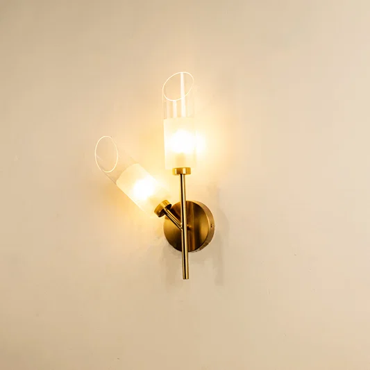 Modern gold metal wall light with clear glass shade for elegant hallway and luxury decor styling spaces.