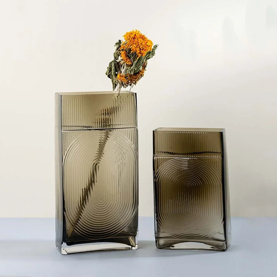 Set of ribbed glass vases in smoke brown finish rectangular tall geometric modern design light on white background for home styling.