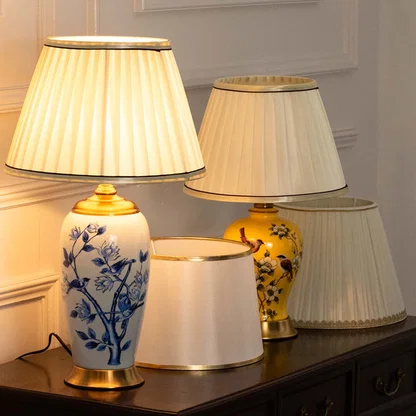 Decorative ceramic table lamps with fabric shades displayed on a console table showcasing classic luxury interior lighting.