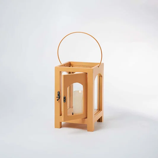 Wooden lantern with arch glass panels and metal handle for rustic tabletop decor styling use.