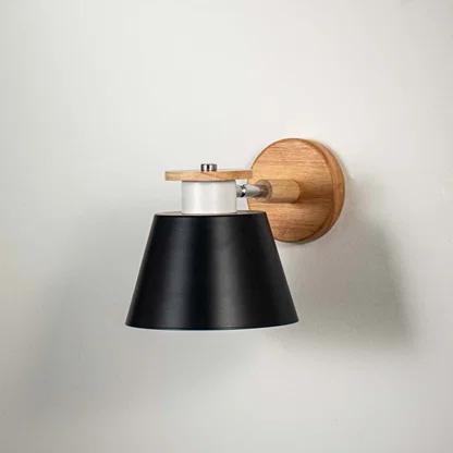 Modern wooden wall sconce with black lampshade light off white background for bedroom study room and hallway stylish wall lighting decor.