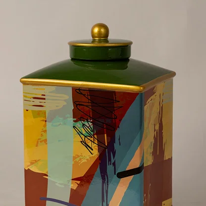 Closeup of abstract design jar showing fine paint detailing and smooth golden lid with glossy texture.
