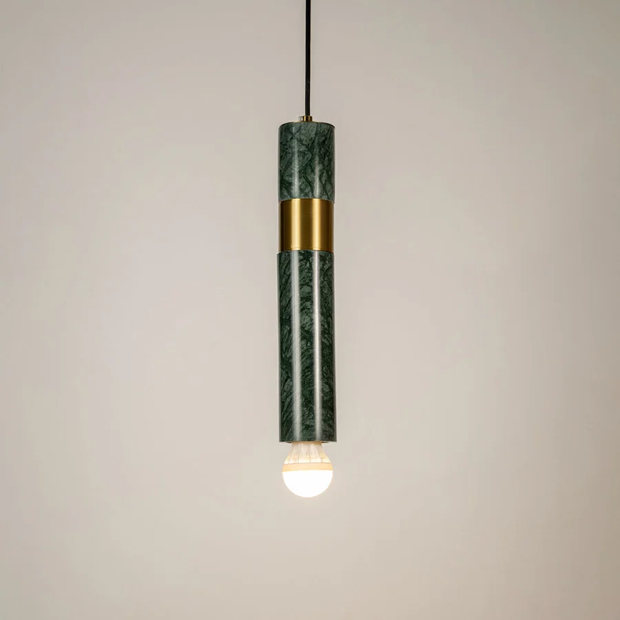 Green metal tube pendant light illuminated to showcase modern decorative ceiling lighting with elegant contemporary styling.