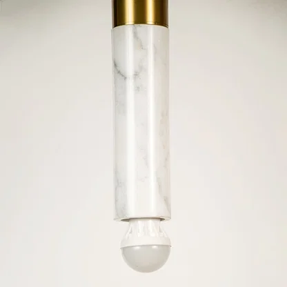 Clear glass and gold metal pendant light closeup highlighting refined detailing and premium lighting craftsmanship.