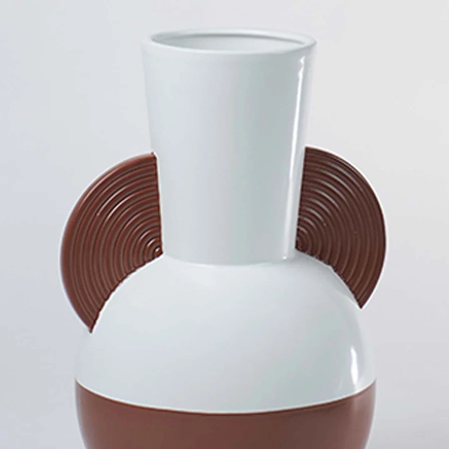 Closeup image of a white and brown bulbous ceramic vase featuring striking brown wood textured half disc side handles.