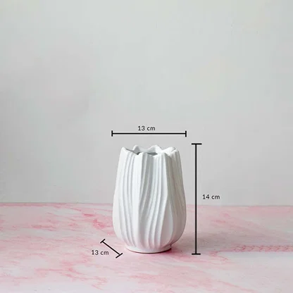 White-ceramic-vase with measurement dimensions 14 cm height and 13 cm width shown on pink marble surface for scale reference.