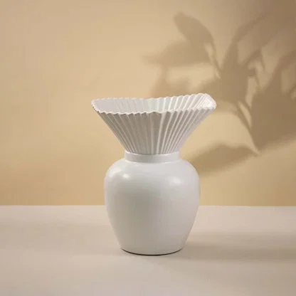 White ceramic vase with textured pleated top and smooth glossy base displayed on white background ideal for minimal home styling.
