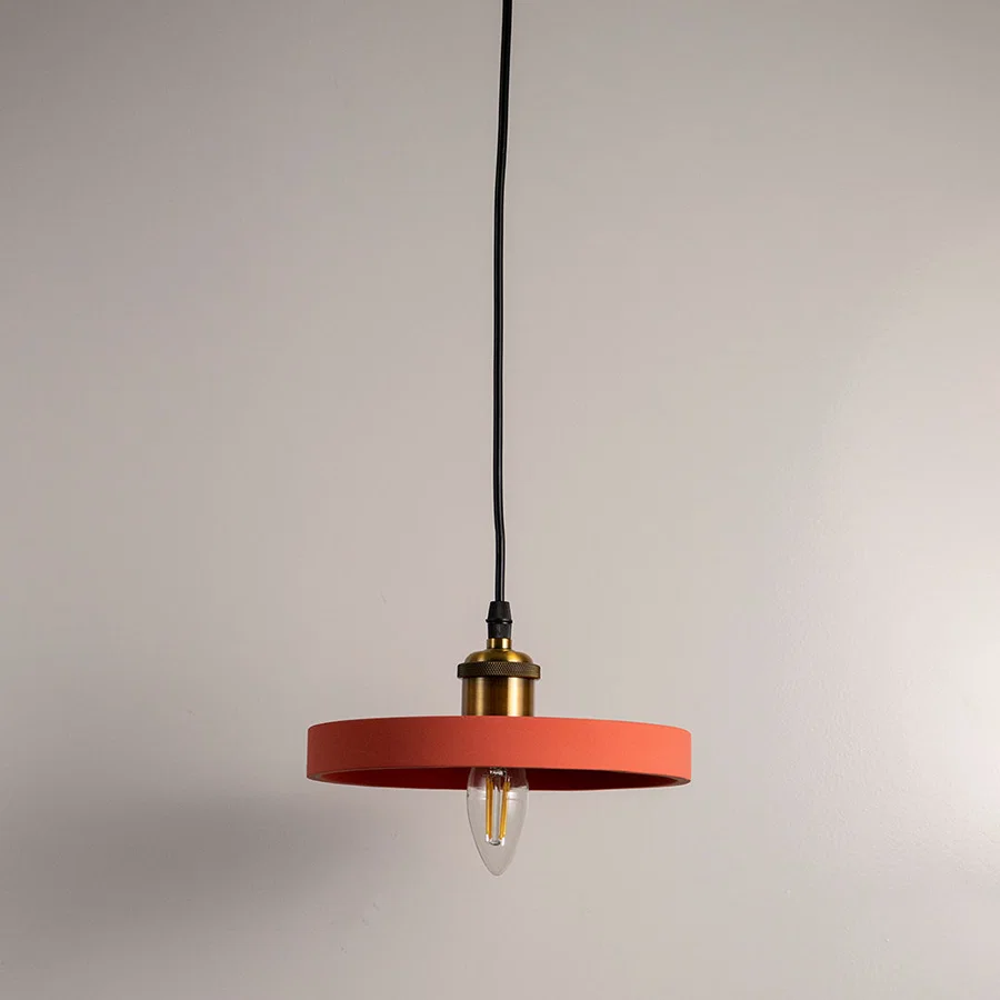Terracotta orange metal pendant light with flat disc shade designed for stylish modern interiors.