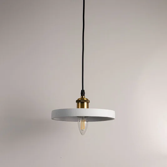 Minimalist black metal pendant light with gold fittings designed for contemporary interiors.