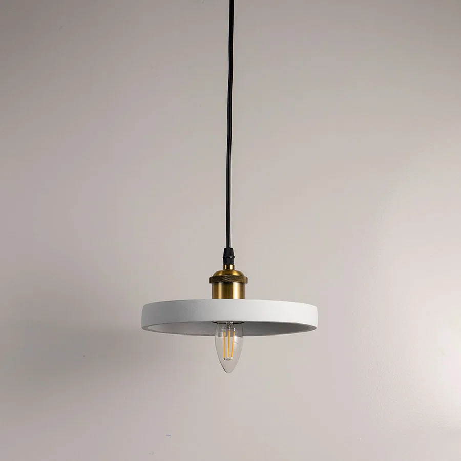 Minimalist black metal pendant light with gold fittings designed for contemporary interiors.