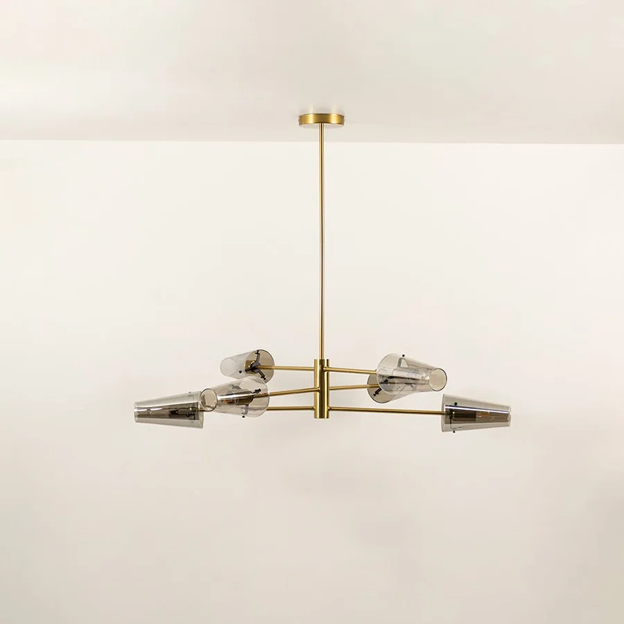 Clear glass shade chandelier with gold metal frame designed for elegant modern ceiling lighting in contemporary interiors.
