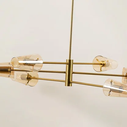 Clear glass shade chandelier with gold metal detailing showcasing refined craftsmanship and modern decorative lighting.