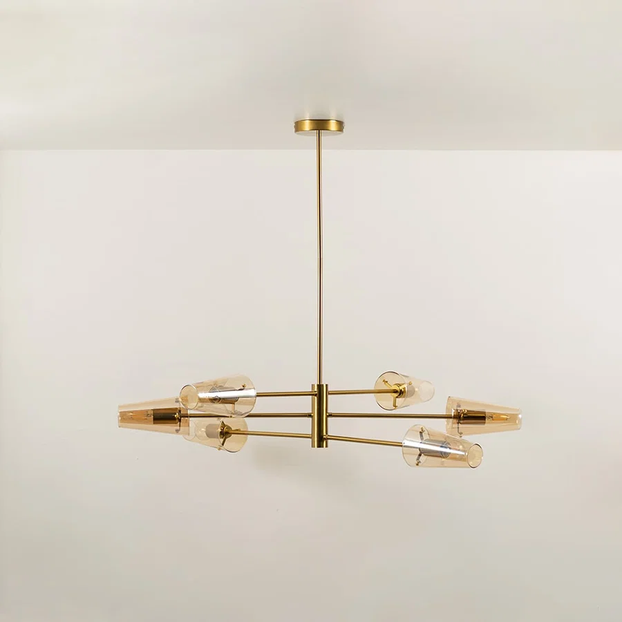 Clear glass shade chandelier with gold metal frame designed for elegant modern ceiling lighting in stylish interiors.