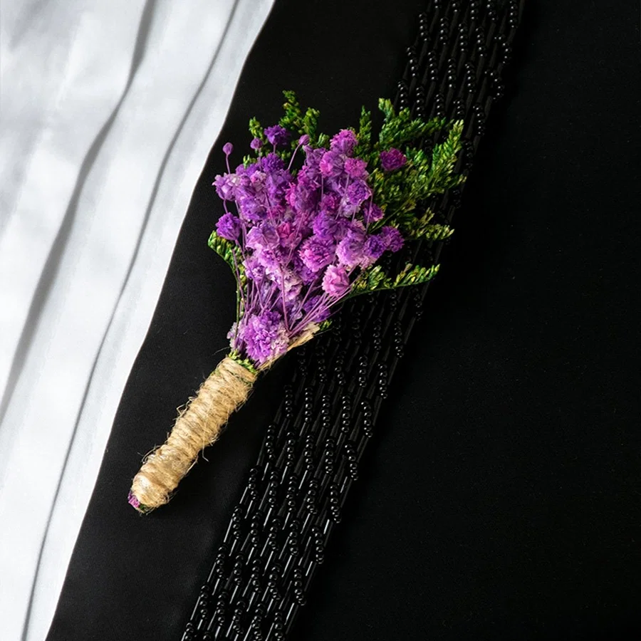 Closeup of preserved purple flower bouquet with green leaves wrapped in natural jute – artificial decorative flower.