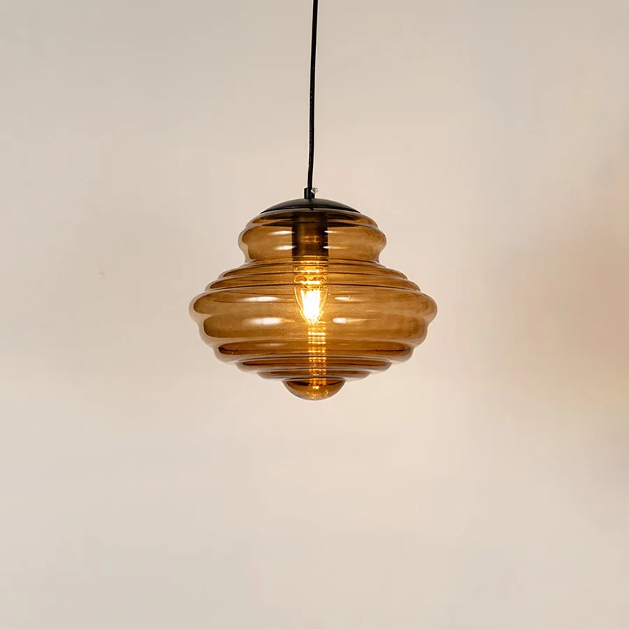 Amber ribbed glass pendant light with warm glow and layered design for elegant modern ceiling lighting in homes.