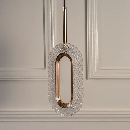 Closeup of gold metal pendant light with oval frame showcasing refined finish and premium craftsmanship.