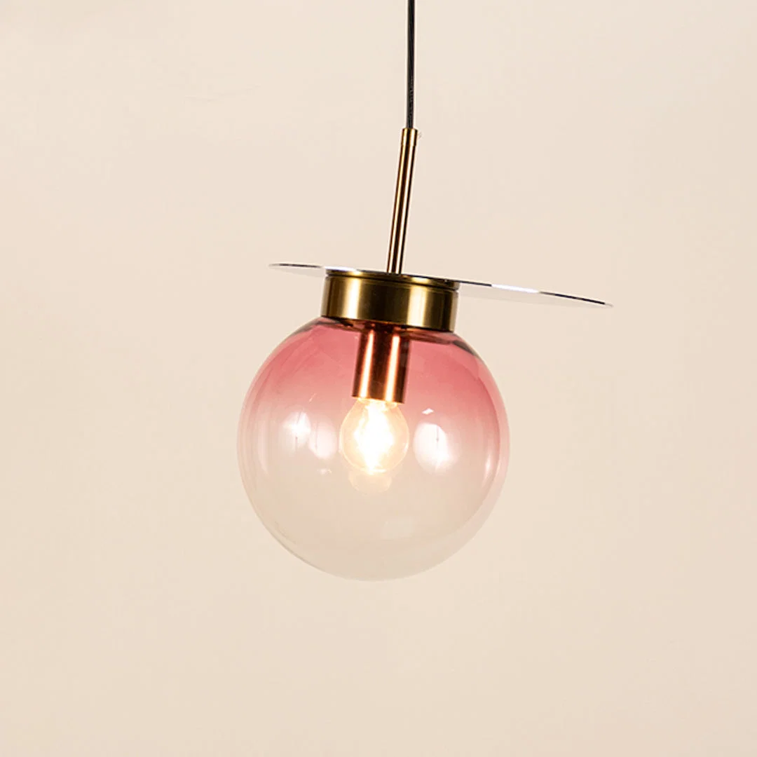 Pink smoked glass pendant light with metal finish and exposed bulb designed for elegant modern ceiling lighting indoors.