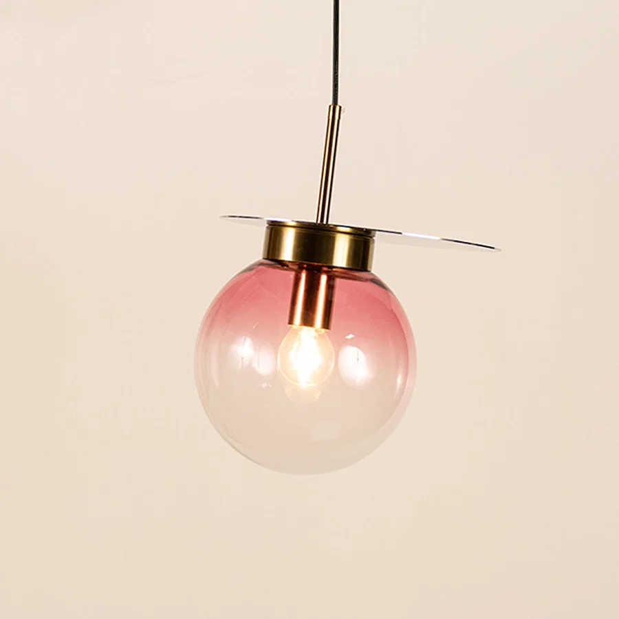 Pink smoked glass pendant light with metal finish and exposed bulb designed for elegant modern ceiling lighting indoors.