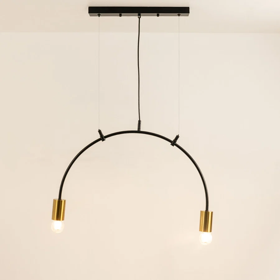 Black and gold metal arc pendant light with illuminated tube shades creating modern ambient ceiling lighting indoors.