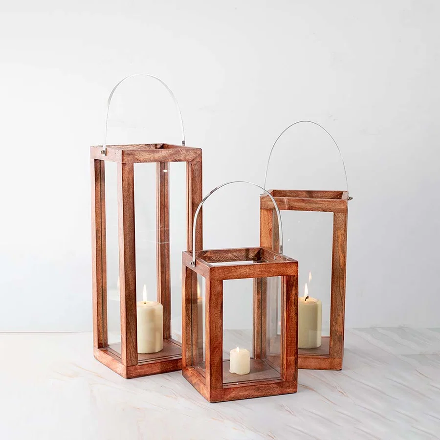 Copper metal lantern candle holders with clear glass panels for modern tabletop and festive home decor styling.