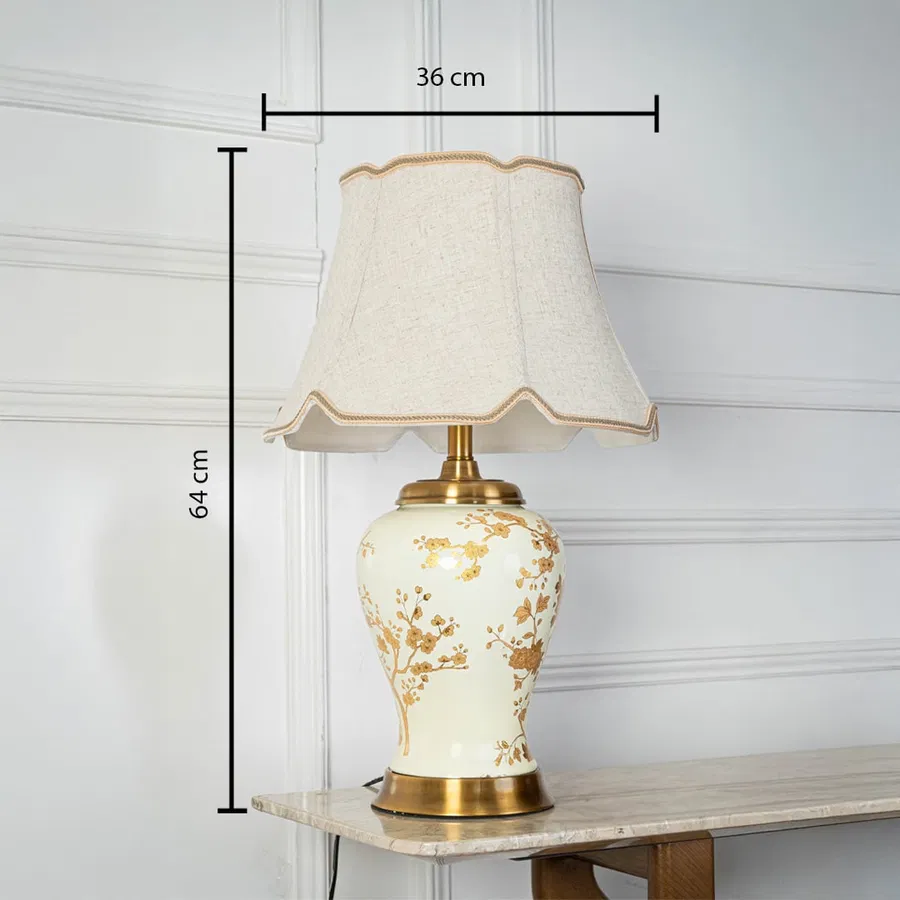 Table lamp with cream ceramic base and fabric shade shown with 36 cm width and 64 cm height for accurate decor placement.