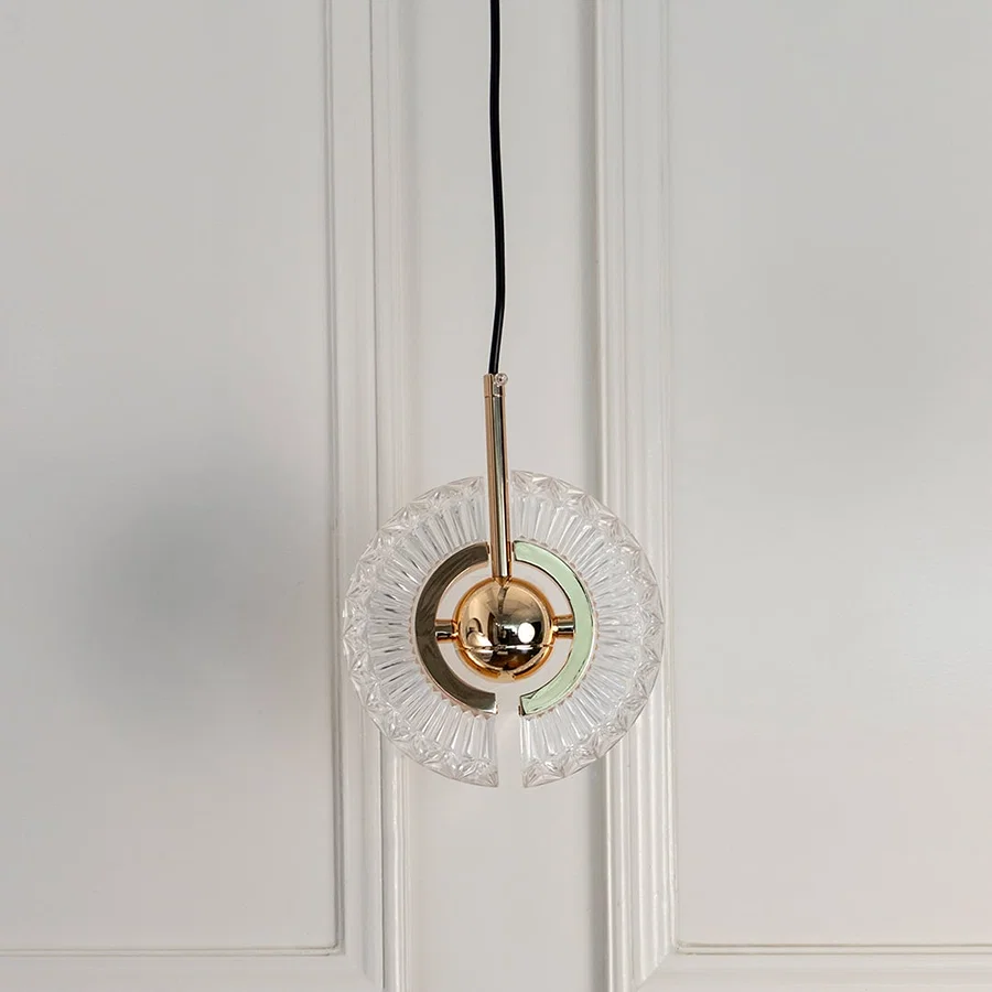 Modern crystal pendant light with polished gold accents designed for sophisticated living spaces.