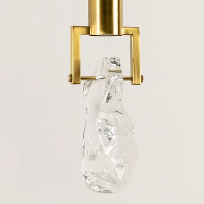 Gold metal pendant light closeup featuring crystal accent detailing and premium luxury lighting craftsmanship quality.