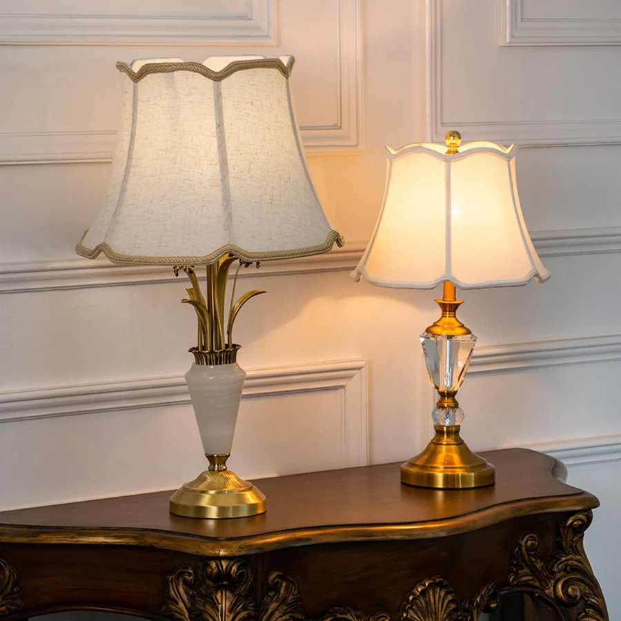 Decorative glass table lamps with fabric shades styled on a console table creating sophisticated traditional ambient lighting.
