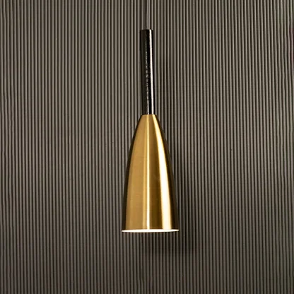 A slim metal pendant light shining softly against a ribbed dark backdrop creating elegant focused illumination and minimal refined modern décor.