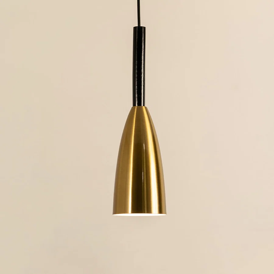 Gold metal cone pendant light illuminated to display sleek modern ceiling lighting with luxury decorative elegance.