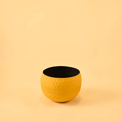 Yellow round textured pot with ribbed design and matte finish displayed on a clean white background for minimal modern decor.