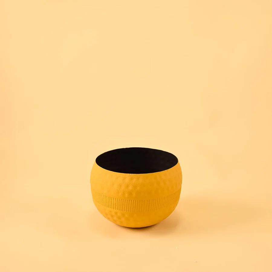 Yellow round textured pot with ribbed design and matte finish displayed on a clean white background for minimal modern decor.