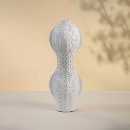 White ceramic decorative vase with sculptural double bulb silhouette for artistic shelf styling and home decor.
