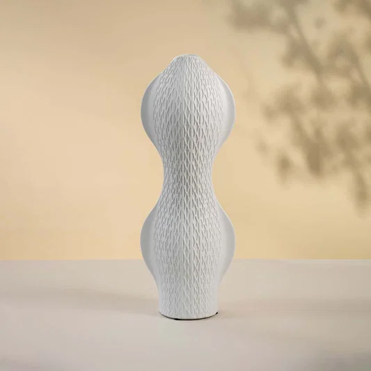 White ceramic decorative vase with sculptural double bulb silhouette for artistic shelf styling and home decor.