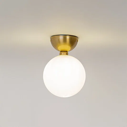 Modern white glass globe ceiling light with gold metal fixture for stylish hallway and luxury decor spaces.