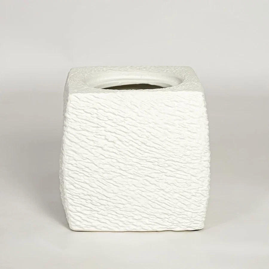 White decorative textured ceramic planter on white background modern home decor accent piece for table floor console styling.