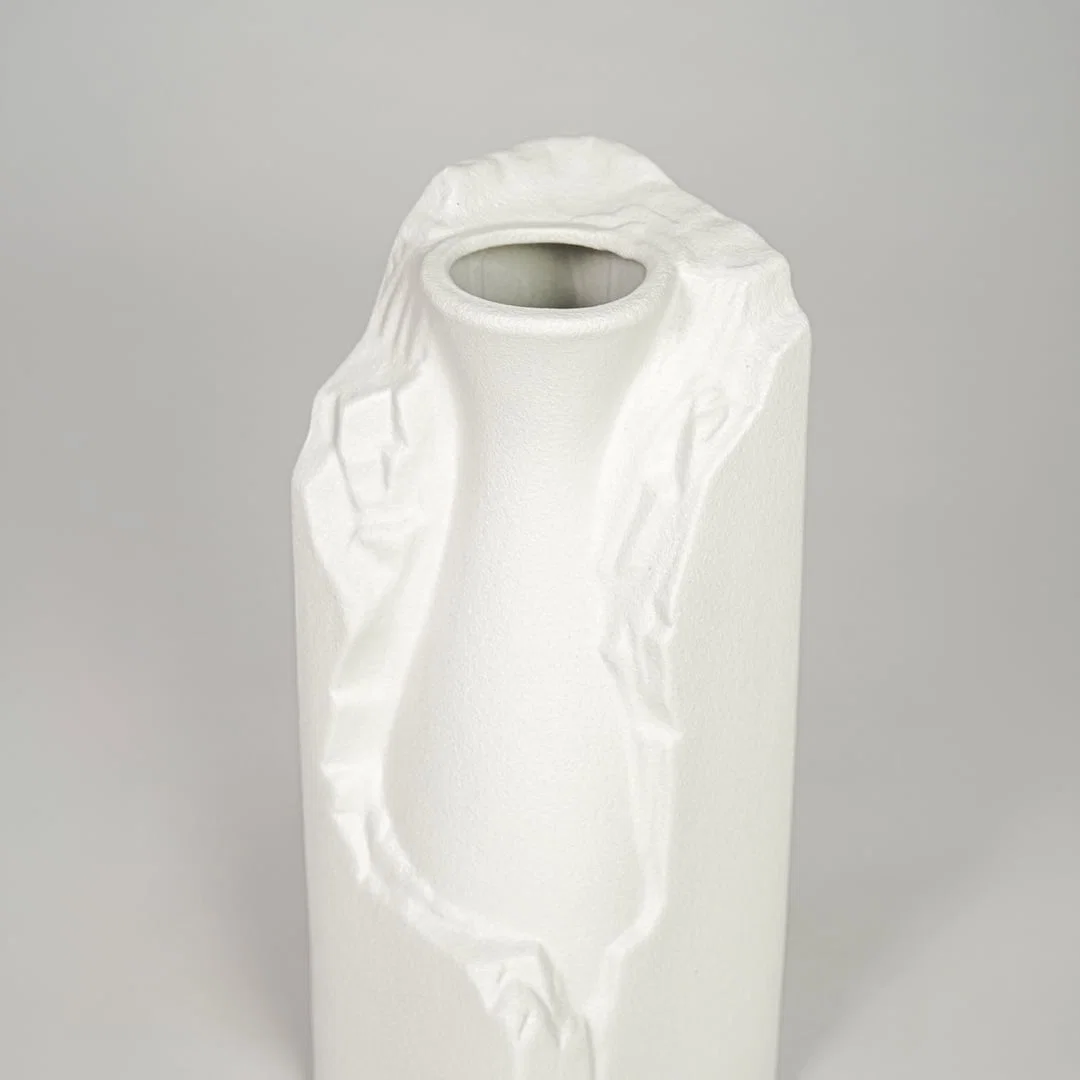 White ceramic flower vase closeup with textured finish modern decorative vase for shelf console table decor styling.