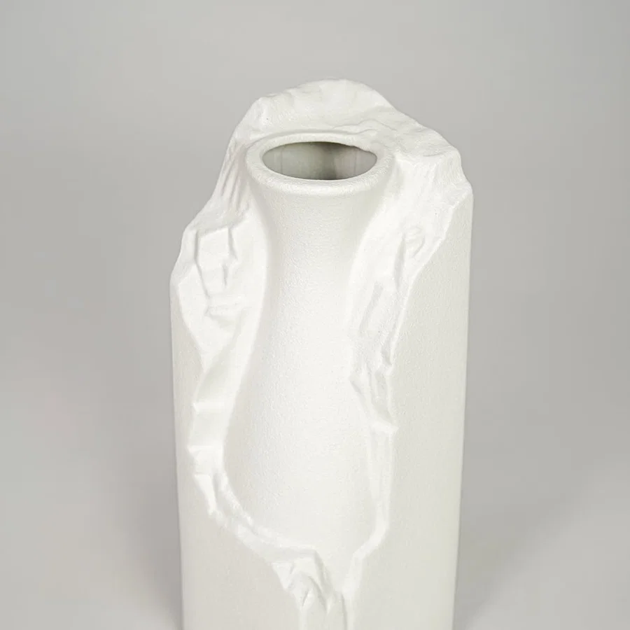 White ceramic flower vase closeup with textured finish modern decorative vase for shelf console table decor styling.